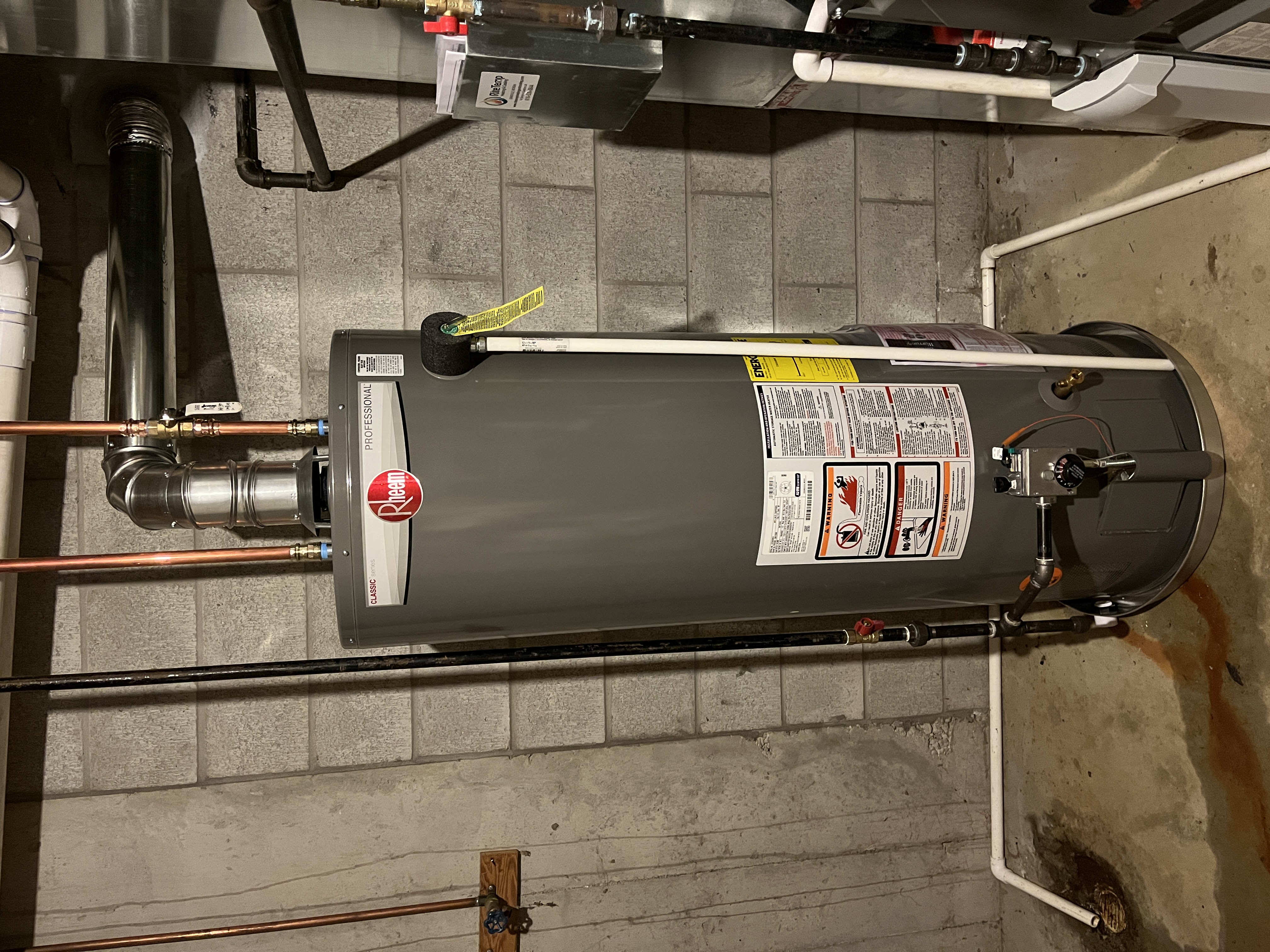 A newly installed Rheem 50 gallon atmospheric natural draft water heater in a Jenison basement, matching the review from Mark Peterson.